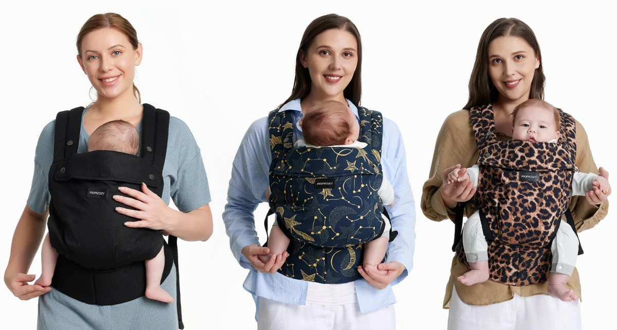 Três mulheres apresentam porta-bebés em diferentes cores: preto, azul-marinho com estrelas e padrão leopardo